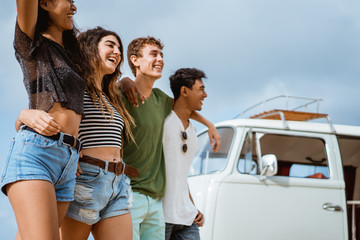 putting arms on friend shoulders front vintage van