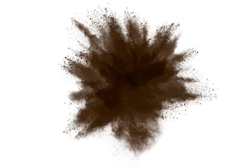 Abstract brown powder explosion. Closeup of brown dust particle splash isolated on white background