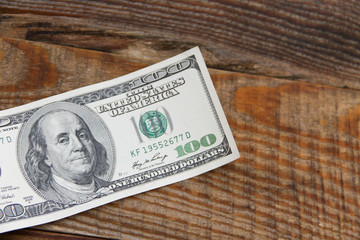 One hundred american dollars banknote on wooden table