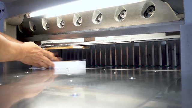 Printing factory - big industrial cutter for cutting paper shears - guillotine machine - close up 4K