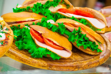 Various sandwiches on a shop counter close up