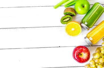 freshly squeezed juices for detox on wooden background top view