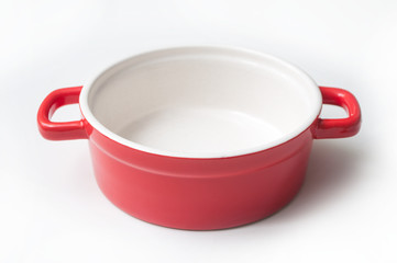 closeup of red ceramic saucepan on white background