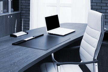 laptop on desk in office