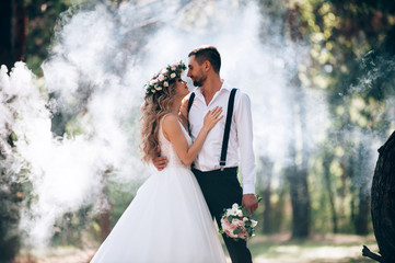 bride and groom on the background of fairy fog in the forest. Rustic wedding concept