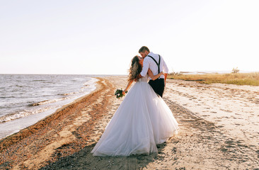 Fototapeta na wymiar bride and groom on the seashore. wedding concept on the sea, on a fabulous island.