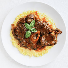 osso buco decotated with basil on risotto 
