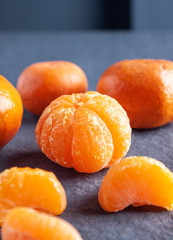 Fresh peeled tangerines over a stone table