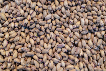 Pile of pistachio close-up as background..