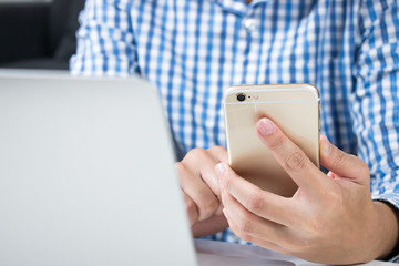 Close up. Man who wear blue shirts are using phones for online shopping.