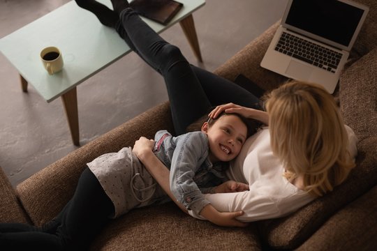 Mother and daughter having fun in living room