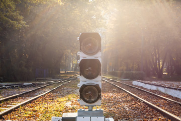 Railway traffic light with baclkight natural sun flare. Railroad station and semaphore in beautiful...
