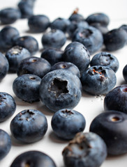 group of blueberries over a white wood table