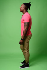 Young handsome African man from Kenya against green background