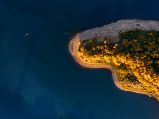 autumn deserted blue lake and green forests on sunny summer day in Finland.