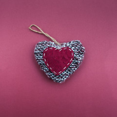 Stylish knitted heart on a simple background. Minimalism, View from above, flat lay