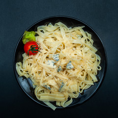Cooked Tagliatelle in a Plate with Parmesan and Blue Cheese, stylish bright photo. View from above, flat lay