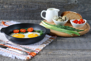 Breakfast on the table. Fried chicken eggs and fresh vegetables.