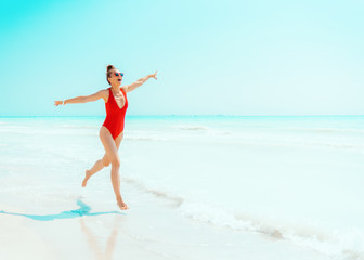 smiling modern woman on seashore having fun time