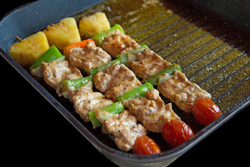 Barbecue pork grilled in the pan on black background