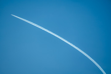 Trail from an airplane in the blue sky