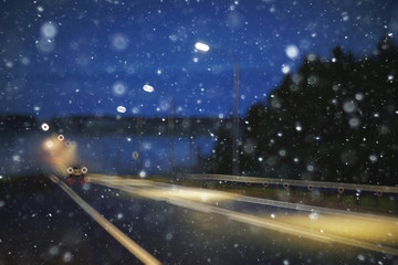 Fototapeta na wymiar blurred transport background snow / traffic on a winter highway, seasonal auto concept, blurry auto texture, traffic jams