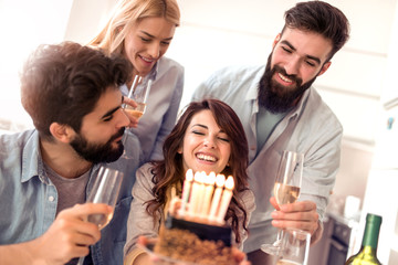 Group of friends celebrating birthday at home
