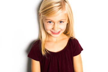A Cute girl 5 year old posing in studio