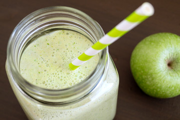 Healthy detox green smoothie in a mason jar.