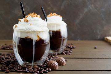 Coffee in double-walled glass on a wooden table.
