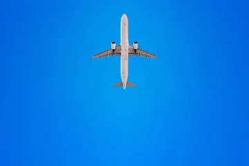 Fotobehang airplane flies into a perfect blue sky © frank peters
