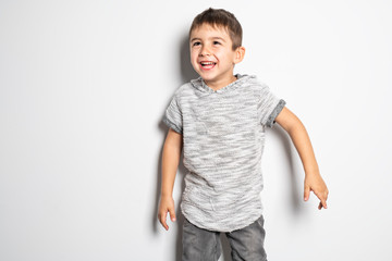 Boy having fun on studio white background