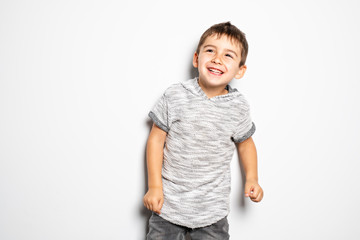 Boy having fun on studio white background