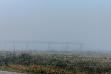 Fototapeta na wymiar railway in fog on field
