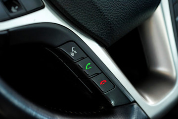 Naklejka premium Phone control buttons on the steering wheel close