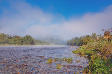 Fog blending over the river, summertime morning landscape