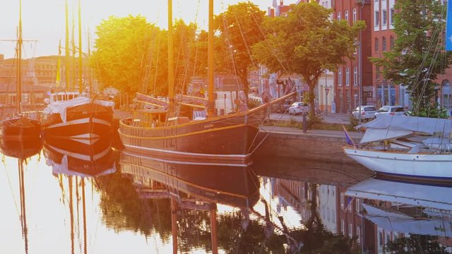 Boats or vessels on the Trave river. Embankment in Lubeck city. 