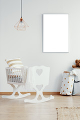 Mockup poster on the wall of trendy baby room interior with doted paper bag and crib with pillows