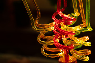 Color tubes for drinking juices. Curved in the form of a spiral. Blurred bright background...