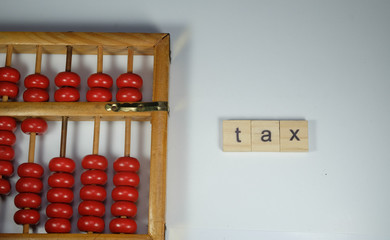 Abacus with word tiles tax.