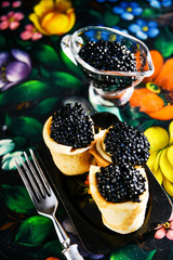 Russian Maslenitsa, pancakes with black caviar. Shrovetide, pancake week, carnival, shrove, pancake day.