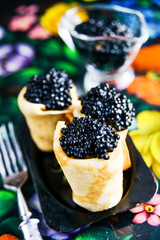 Russian Maslenitsa, pancakes with black caviar. Shrovetide, pancake week, carnival, shrove, pancake day.