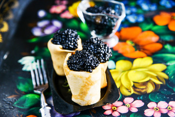 Russian Maslenitsa, pancakes with black caviar. Shrovetide, pancake week, carnival, shrove, pancake day.