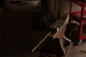 Hammer tool on anvil in workshop