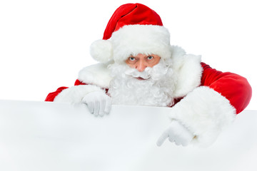 bearded santa claus pointing at blank board isolated on white