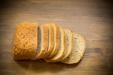 fresh homemade bread sliced on wooden background