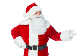 bearded santa claus showing something at christmastime isolated on white