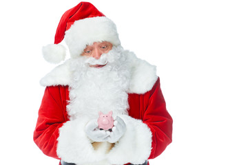 santa claus holding little piggy bank isolated on white
