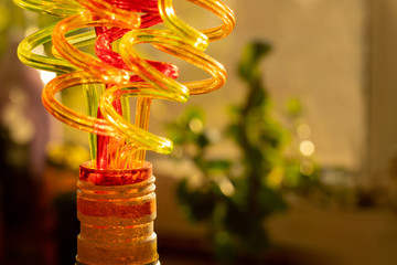 Color tubes for drinking juices. Curved in the form of a spiral. Blurred bright background...