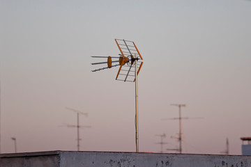 Closeup image of TV antenna at dusk.